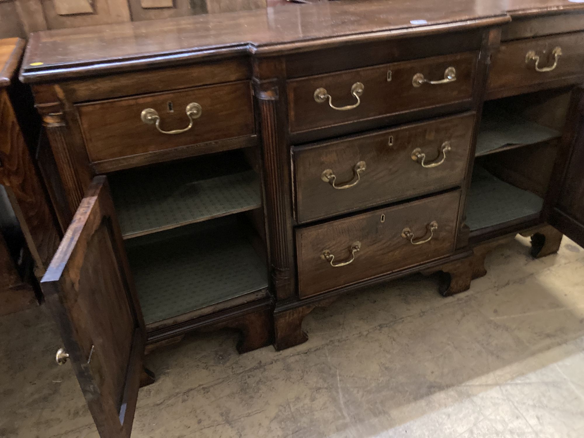 A George III style cross banded oak break front low dresser, width 50cm, depth 47cm, height 83cm